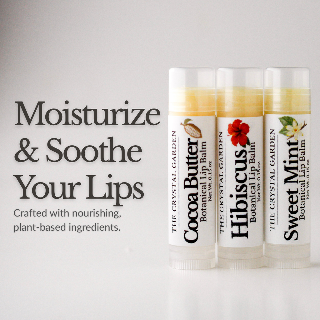 Three lip balm tubes from The Crystal Garden are displayed on a light gray background with promotional text on the left. The tubes are labeled Cocoa Butter, Hibiscus, and Sweet Mint botanical lip balm.