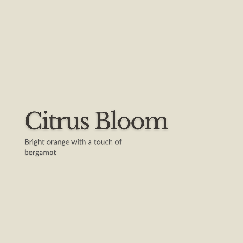 A flat warm beige background with centered text reading 'Citrus Bloom' and smaller text below saying 'Bright orange with a touch of bergamot.'.