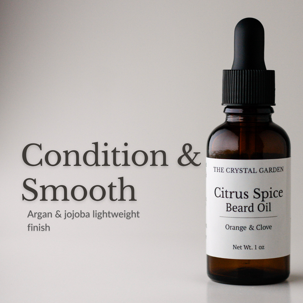 Amber glass dropper bottle of The Crystal Garden Citrus Spice Beard Oil with a white label, shown next to text on a light gray background reading 'Condition & Smooth'.