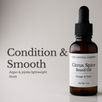 Amber glass dropper bottle of The Crystal Garden Citrus Spice Beard Oil with a white label, shown next to text on a light gray background reading 'Condition & Smooth'.