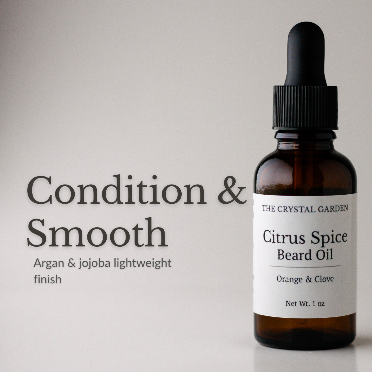 Amber glass dropper bottle of The Crystal Garden Citrus Spice Beard Oil with a white label, shown next to text on a light gray background reading 'Condition & Smooth'.