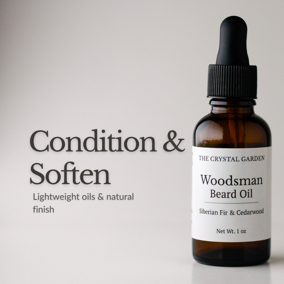 Amber glass dropper bottle of The Crystal Garden Woodsman Beard Oil with a black dropper cap and white label, shown next to text reading 'Condition & Soften' on a light gray background.