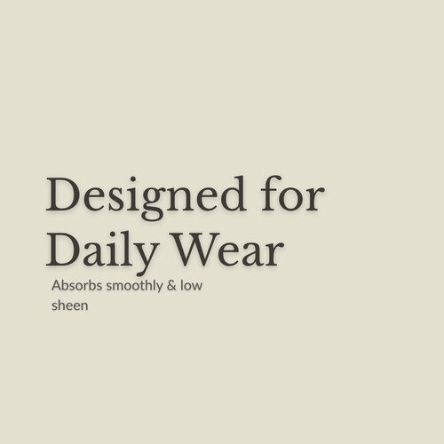 A minimalist beige graphic with dark gray text reading 'Designed for Daily Wear' and smaller text below, 'Absorbs smoothly & low sheen.' No product is shown.