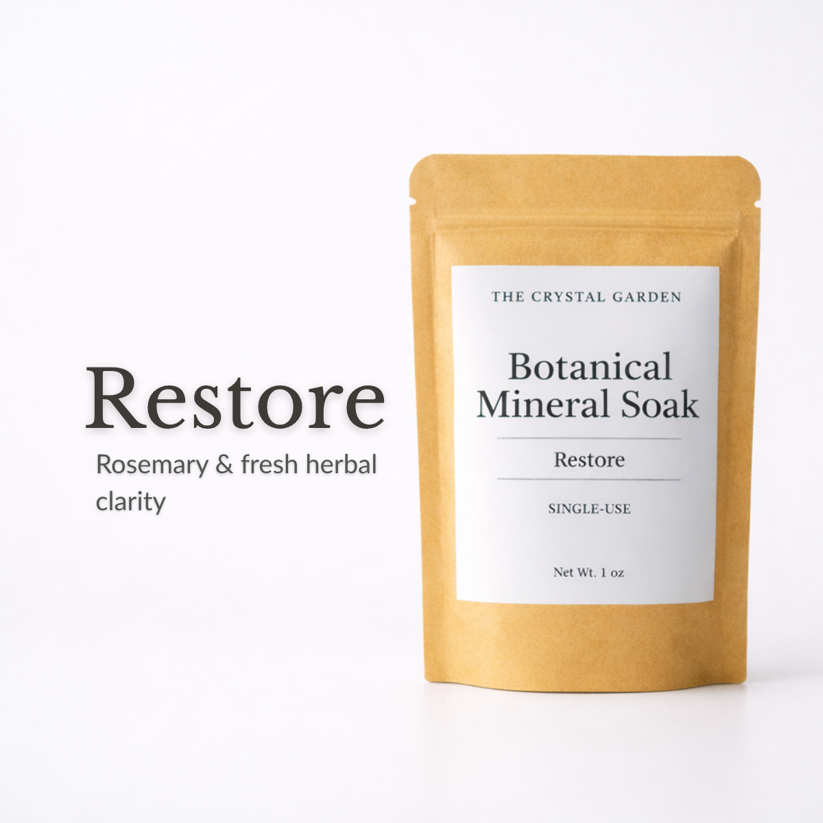 A single-use kraft paper pouch of The Crystal Garden Restore Botanical Mineral Soak, shown next to the text 'Restore Rosemary & fresh herbal clarity' on a clean white background.