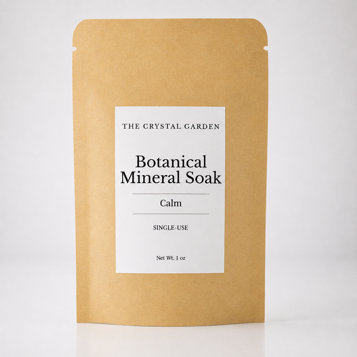 A single-use stand-up pouch of The Crystal Garden Botanical Mineral Soak in the 'Calm' scent, made of natural kraft paper with a white label.