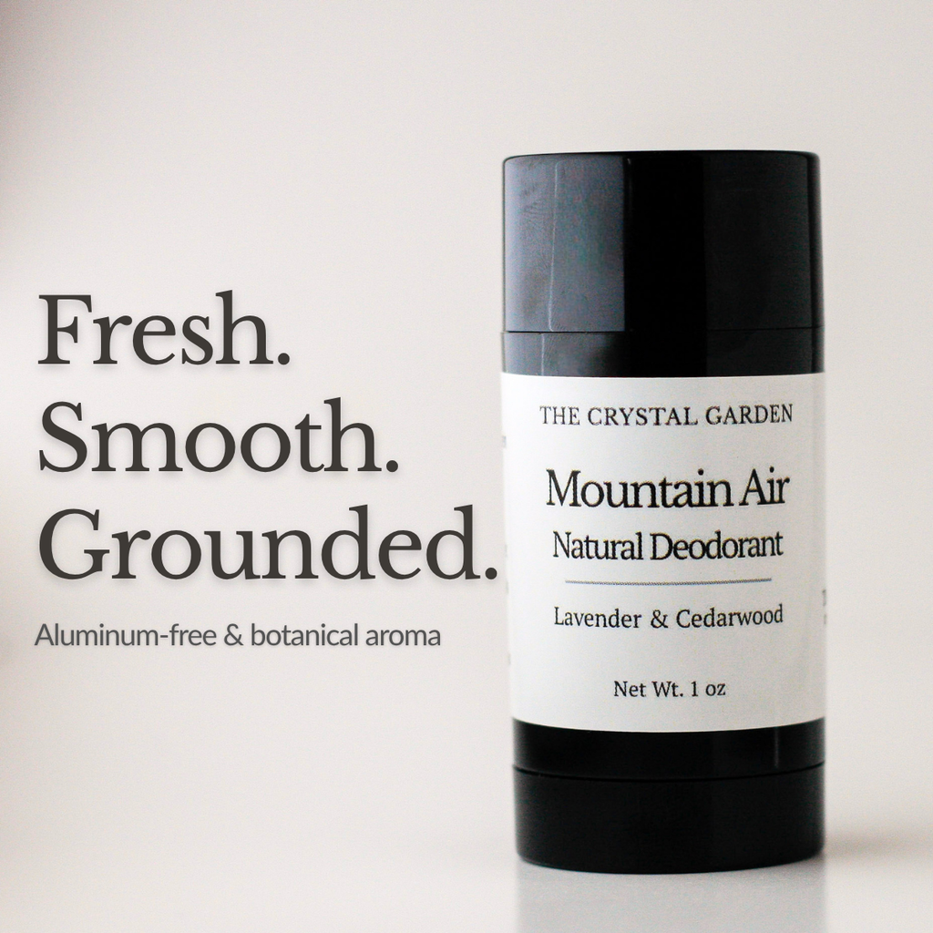A 1 oz deodorant stick from The Crystal Garden, Mountain Air Natural Deodorant, in a black container with a white label. The image includes text on the left reading 'Fresh. Smooth. Grounded. Aluminum-free and botanical aroma'
