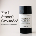 A 1 oz deodorant stick from The Crystal Garden, Mountain Air Natural Deodorant, in a black container with a white label. The image includes text on the left reading 'Fresh. Smooth. Grounded. Aluminum-free and botanical aroma'