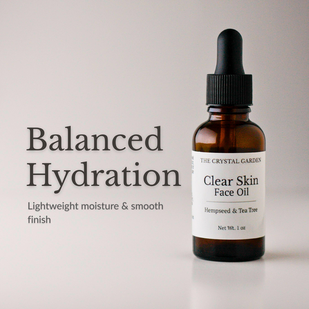 An amber glass dropper bottle of The Crystal Garden Clear Skin Face Oil with a black dropper cap and white label, shown next to text reading 'Balanced Hydration' on a light gray background.