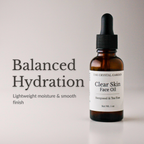 An amber glass dropper bottle of The Crystal Garden Clear Skin Face Oil with a black dropper cap and white label, shown next to text reading 'Balanced Hydration' on a light gray background.