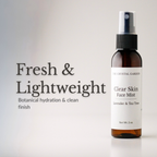 An amber glass spray bottle of face mist with a white label reading 'Clear Skin Face Mist' and 'The Crystal Garden,' shown on a light gray background with the text 'Fresh & Lightweight' and 'Botanical hydration & clean finish.'.