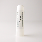 A white cylindrical aromatherapy inhaler tube with a ribbed cap, featuring a white label with black text that reads 'THE CRYSTAL GARDEN Focus Aromatherapy Inhaler'.