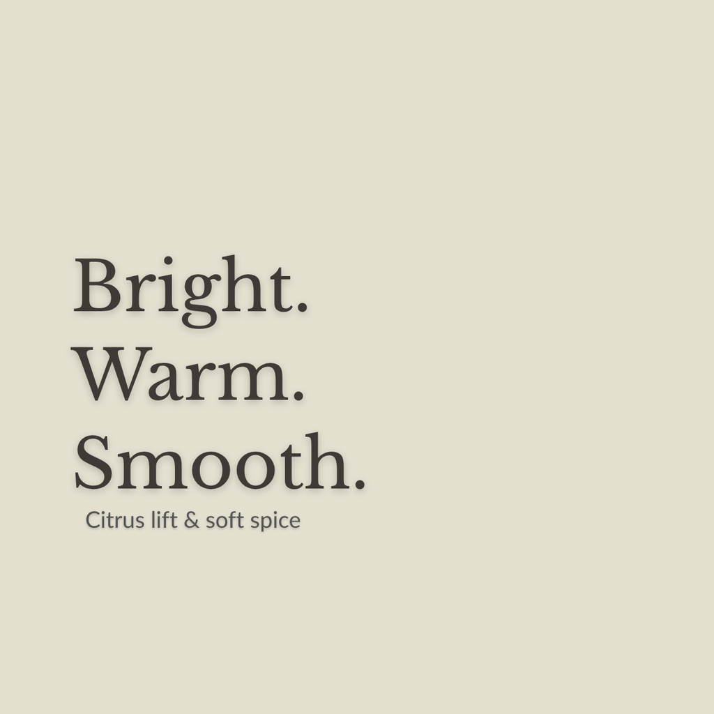 A minimalist beige square graphic with the words 'Bright. Warm. Smooth. Citrus lift and soft spice'