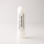 A white cylindrical tube of 'Headache' aromatherapy inhaler by The Crystal Garden, standing upright on a clean white background.