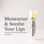 A tube of Sweet Mint Botanical Lip Balm by The Crystal Garden stands on a light gray background next to promotional text that reads 'Moisturize & Soothe Your Lips'.