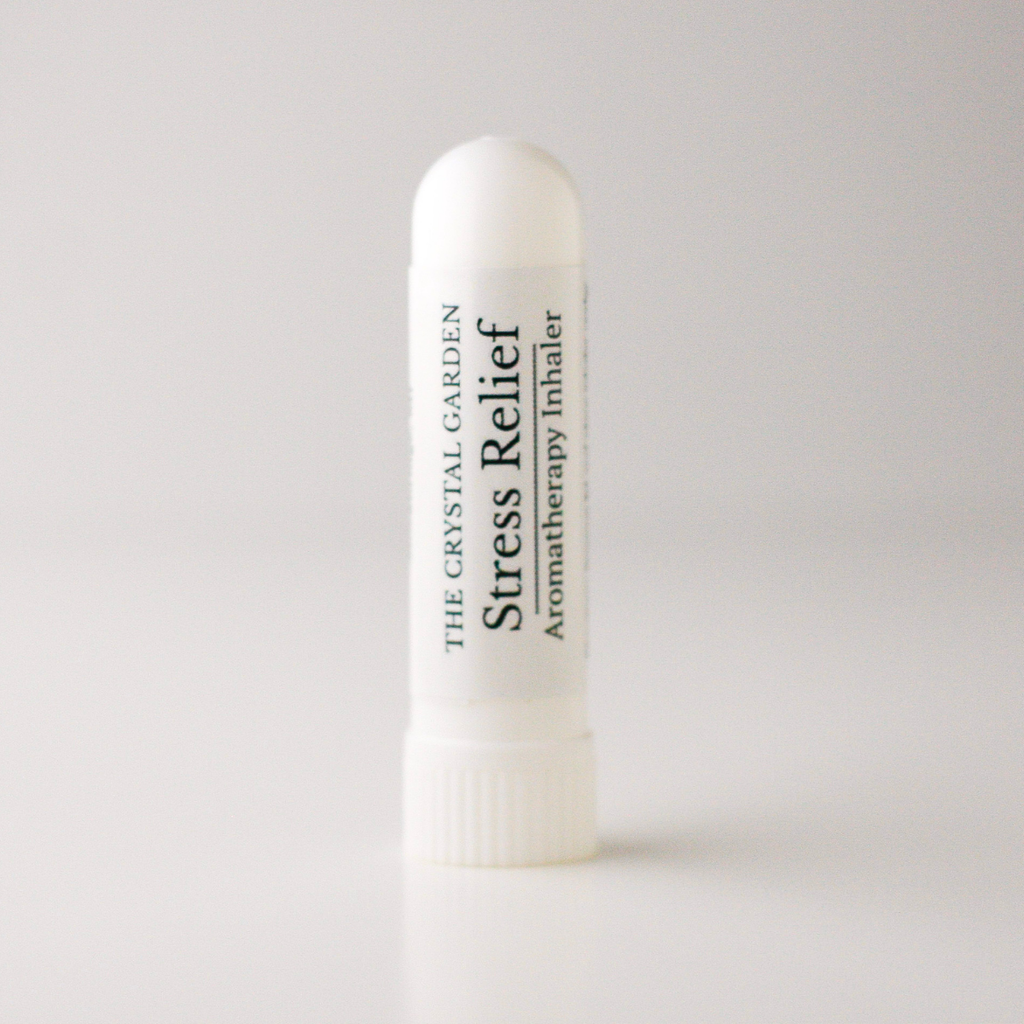 A white cylindrical aromatherapy inhaler tube labeled 'THE CRYSTAL GARDEN Stress Relief Aromatherapy Inhaler' on a light gray background.