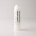 A white cylindrical aromatherapy inhaler tube labeled 'THE CRYSTAL GARDEN Stress Relief Aromatherapy Inhaler' on a light gray background.
