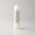 A white cylindrical aromatherapy inhaler tube standing upright on a light gray background. The label reads 'THE CRYSTAL GARDEN Sweet Dreams Aromatherapy Inhaler' in black text.