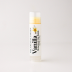 A single tube of lip balm standing upright on a clean white background. The label reads 'Vanilla Botanical Lip Balm' and shows 'The Crystal Garden' with a vanilla flower illustration.