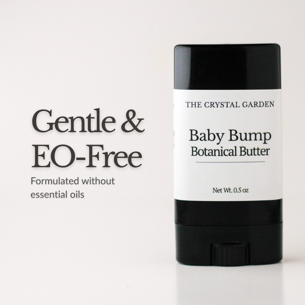 A black and white stick container of The Crystal Garden Baby Bump Botanical Butter, shown next to text that reads 'Gentle & EO-Free' on a clean white background.