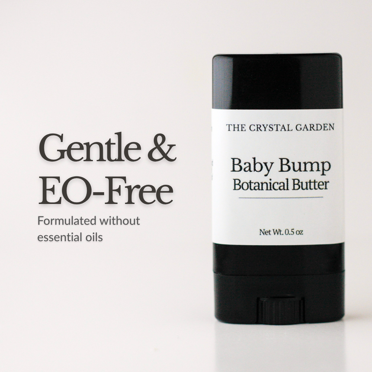 A black and white stick container of The Crystal Garden Baby Bump Botanical Butter, shown next to text that reads 'Gentle & EO-Free' on a clean white background.