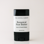 A black and white stick container of The Crystal Garden Botanical Scar Butter, shown on a clean white background.