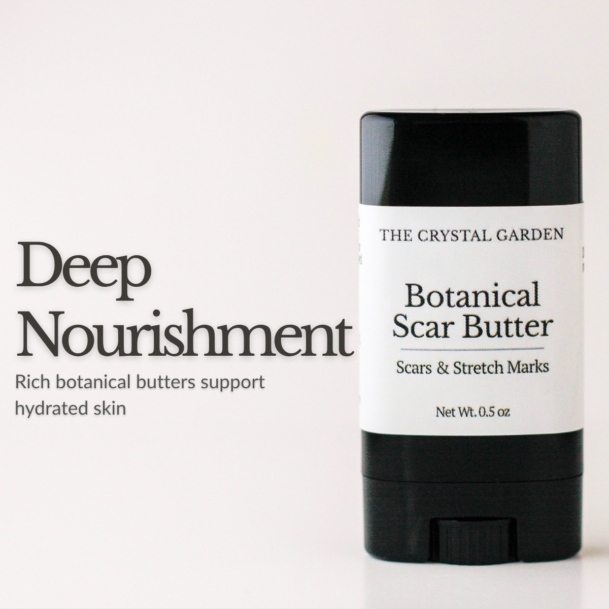 A black and white stick of The Crystal Garden Botanical Scar Butter on a clean white background, with text on the left reading 'Deep Nourishment'.