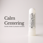 A white cylindrical aromatherapy inhaler tube stands on a light gray background next to the text 'Calm Centering' and 'Gentle inhale & present moment.' The tube is labeled 'The Crystal Garden Birthing Breath Aromatherapy inhaler.