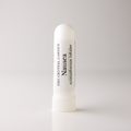 A white cylindrical nasal spray bottle labeled 'Nausea' by The Crystal Garden Aromatherapy Inhaler, standing upright on a light gray background.