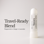 A white travel-ready nausea inhaler by The Crystal Garden stands on a white surface against a light gray background, next to the text 'Travel-Ready Blend' and 'Peppermint • Ginger • Lavender'.