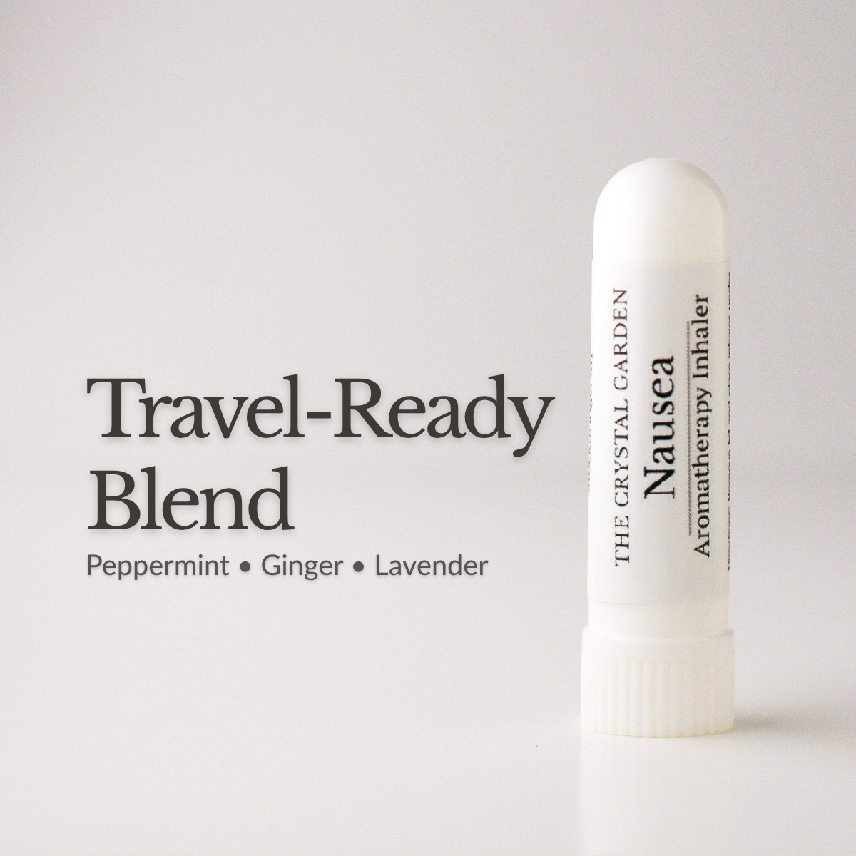 A white travel-ready nausea inhaler by The Crystal Garden stands on a white surface against a light gray background, next to the text 'Travel-Ready Blend' and 'Peppermint • Ginger • Lavender'.