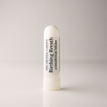 A white cylindrical aromatherapy inhaler tube with a ribbed screw cap, standing upright on a light gray background. The label reads 'THE CRYSTAL GARDEN Birthing Breath Aromatherapy inhaler'.