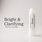 A white cylindrical aromatherapy inhaler tube labeled 'The Crystal Garden Focus Aromatherapy Inhaler' stands on a light gray background next to text reading 'Bright & Clarifying' and 'Mint lift & citrus light'.