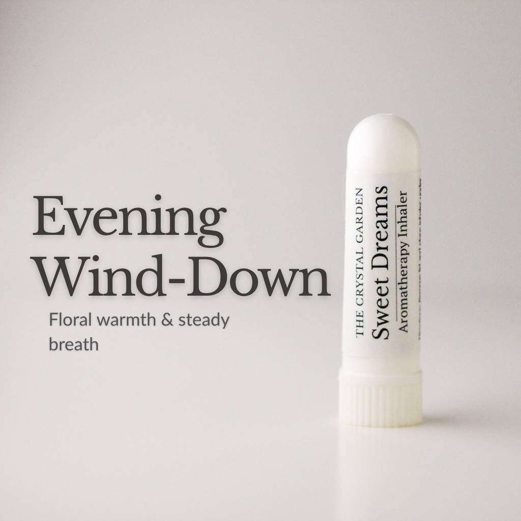 A white cylindrical aromatherapy inhaler bottle labeled 'Sweet Dreams' by The Crystal Garden, shown on a light gray background with the text 'Evening Wind-Down' and 'Floral warmth & steady breath' to the left.