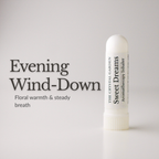 A white cylindrical aromatherapy inhaler bottle labeled 'Sweet Dreams' by The Crystal Garden, shown on a light gray background with the text 'Evening Wind-Down' and 'Floral warmth & steady breath' to the left.