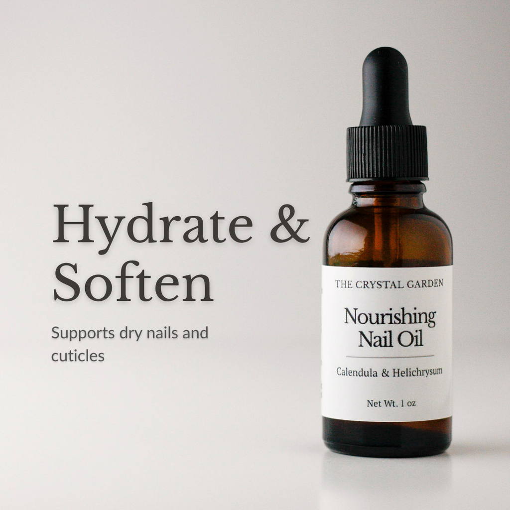 Amber glass dropper bottle of The Crystal Garden Nourishing Nail Oil with a white label and black dropper cap, shown on a light gray background with the text 'Hydrate & Soften' and 'Supports dry nails and cuticles'.
