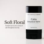 A single stick of botanical salve by The Crystal Garden in the 'Soft Floral' scent, shown on a clean white background with descriptive text on the left.