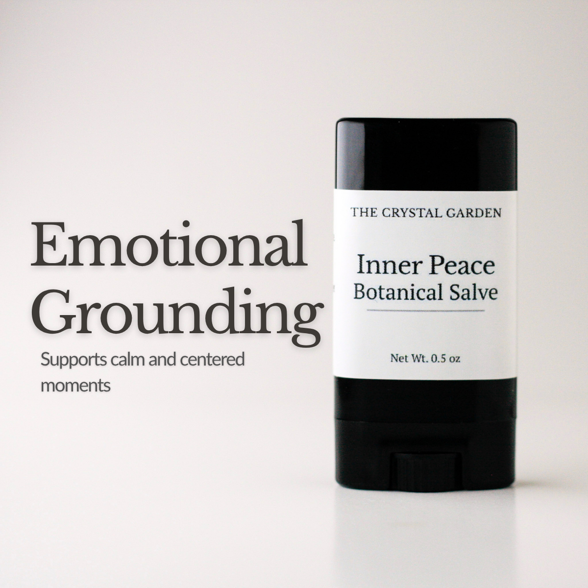 A black and white deodorant-style stick labeled 'The Crystal Garden Inner Peace Botanical Salve' stands on a light neutral background beside large text reading 'Emotional Grounding' and smaller supporting text.